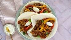 Cheesy Steak Fajitas with Peppers and Sour Cream