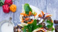 Spicy Harissa lamb shoulder chunks in pita cones with Tahini sauce